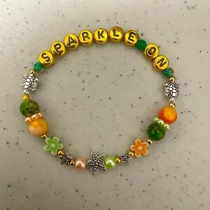 Sparkle on bracelet handmade with turtles, flowers, stars. So cute.